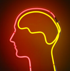 Neon light brain in the head of a human